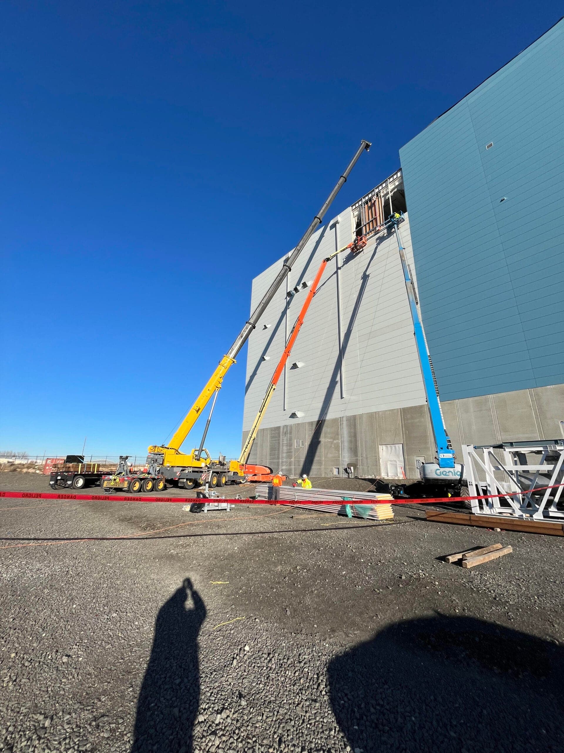 Crane crew installing wall panels on a large commercial building in Eastern Washington
